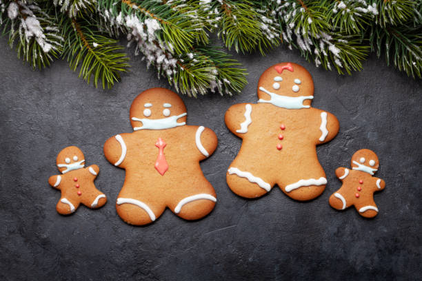 istock Greeting card with gingerbread cookies in face mask 1290223170