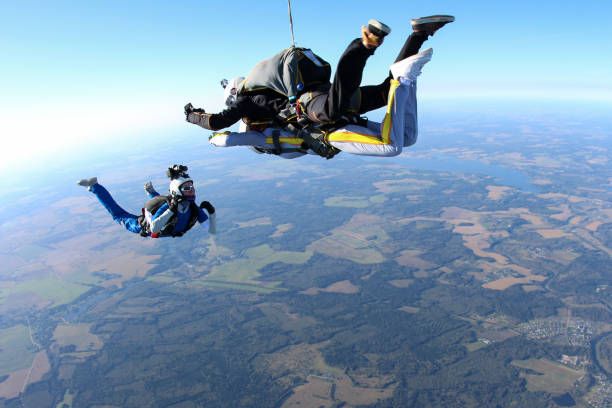 istock Skydiving. Tandem jump and cameraman. 1290224966