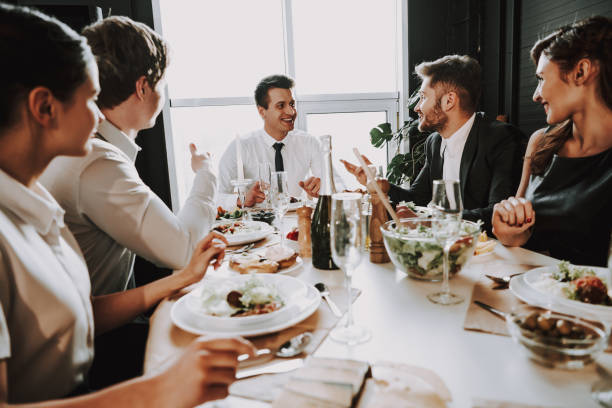 istock Group of friends at dinner table at home. 1290225060