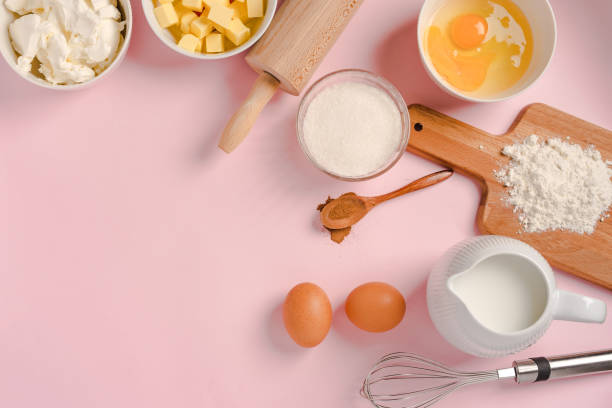 istock Baking ingredients and tools on a pink pastel background, top view. Cooking process and place for text 1290225409