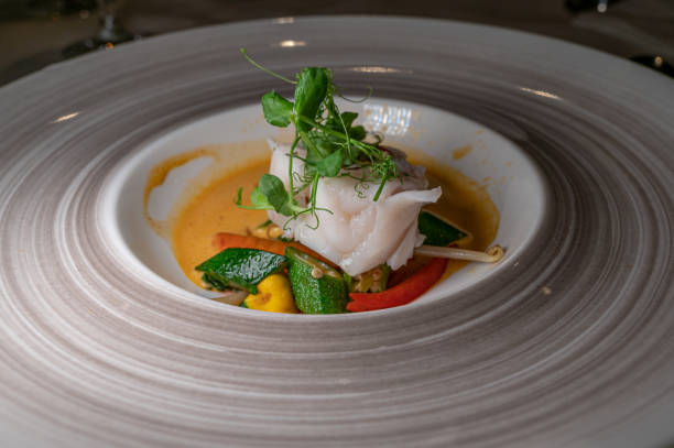 istock Fish dish with vegetable and salads. Monkfish medallions. 1290225428