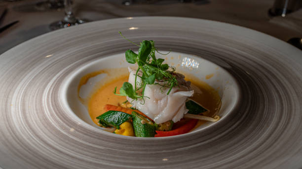istock Fish dish with vegetable and salads. Monkfish medallions. 1290225435