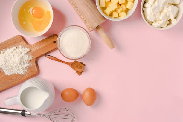 istock Baking ingredients and tools on a pink pastel background, top view. Cooking process and place for text 1290225452