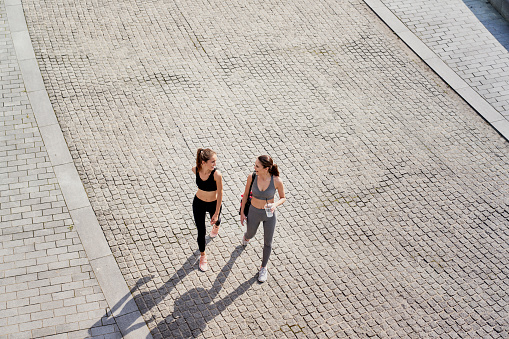 Top view of two women going in training clothes outdoor