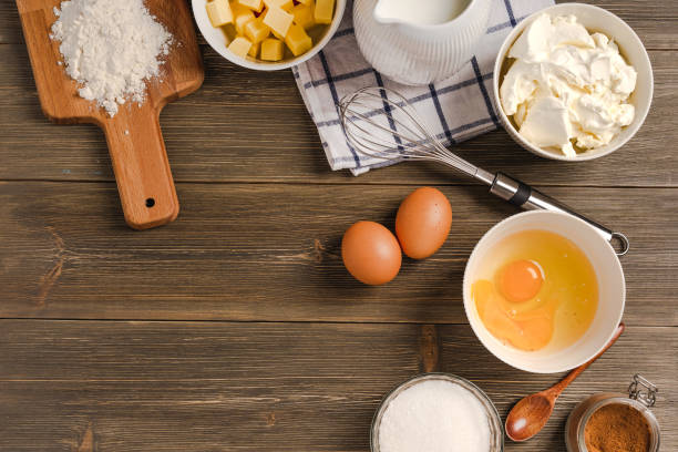 istock Cooking composition of items and products for baking on a wooden table, top view. Baking or cooking background frame. 1290225662