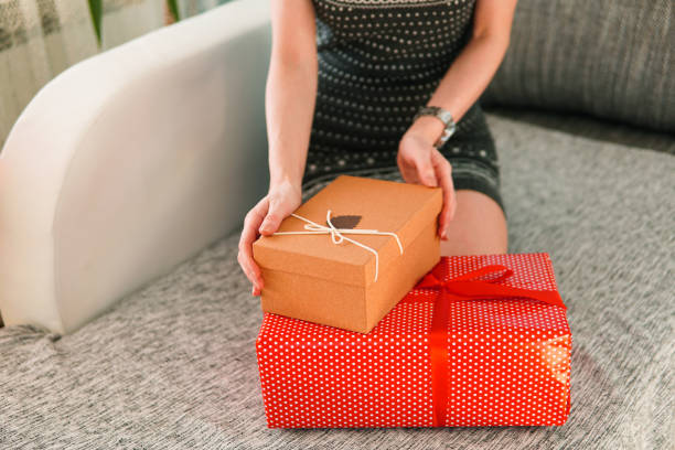 istock Woman holding a christmas present, wrapped gift boxes 1290226434