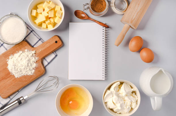 istock Top view of an empty notepad for writing down a recipe and various ingredients for baking pastry and kitchen tools 1290226657