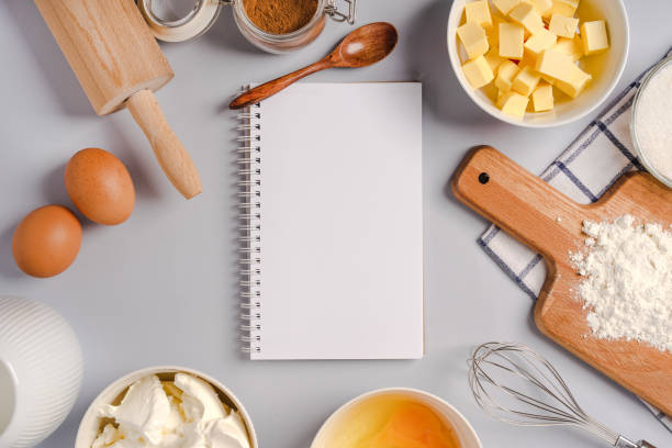 istock Top view of an empty notepad for writing down a recipe and various ingredients for baking pastry and kitchen tools 1290226682