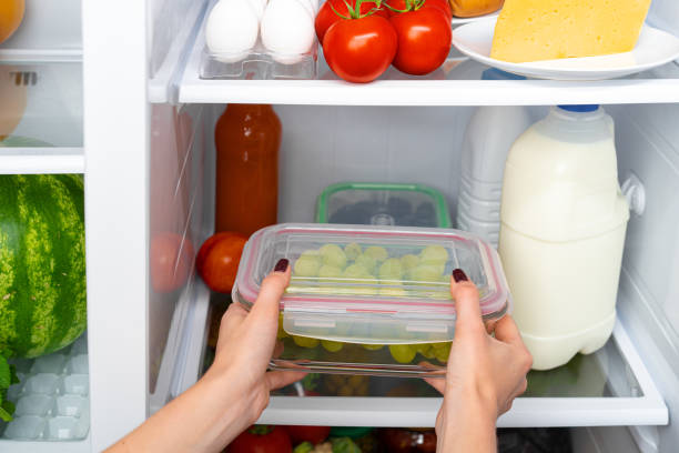 istock Female hands taking storage box with food from a fridge 1290228096