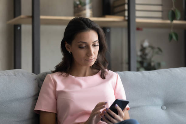 istock Serious young arabian indian woman using telephone applications. 1290228370