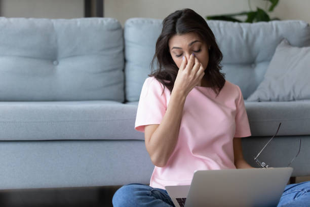 istock Exhausted young arabic indian woman taking off glasses. 1290228413