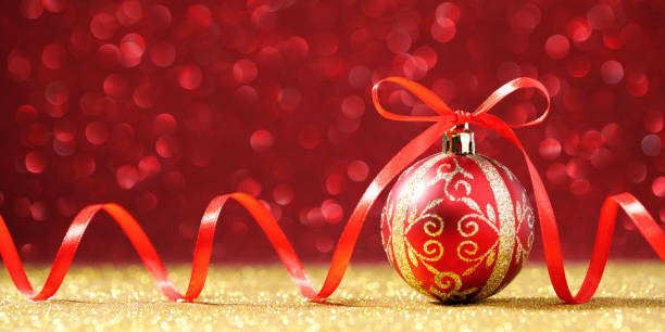 istock Red Christmas sphere with bow on glitter background 1290228731