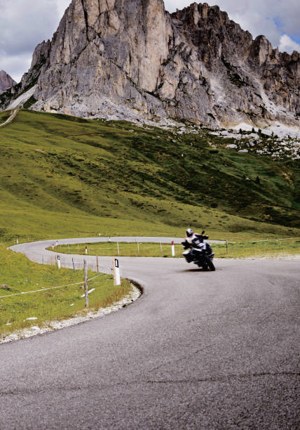 istock Biker Riding on Winding Road. 1290228895