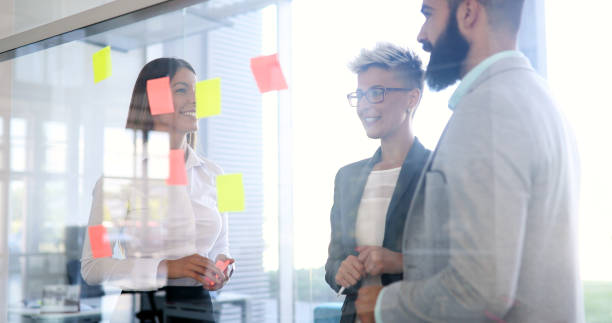 istock Business colleagues collaborating and discussing project plans 1290228942