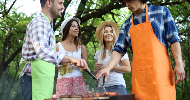 istock Friends making barbecue and having lunch in the nature 1290229052