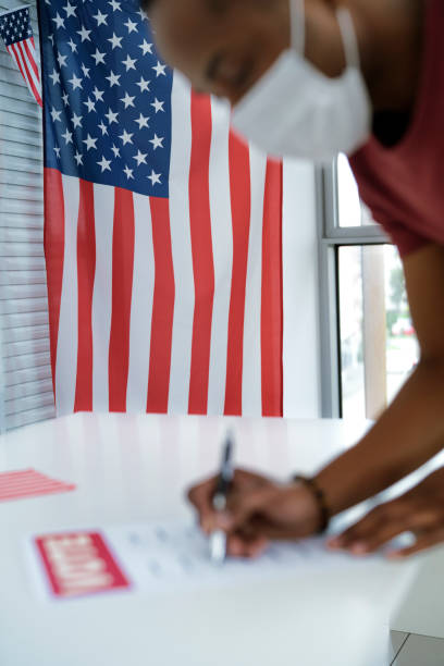 istock American flag and man voting in face mask 1290229781