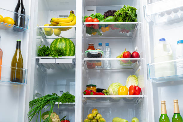 istock Open fridge full of fruits, vegetables and drinks 1290230425