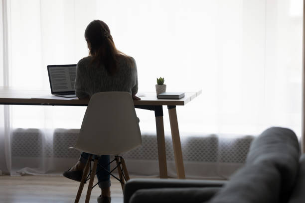 istock Concentrated young female freelance working on computer. 1290230594