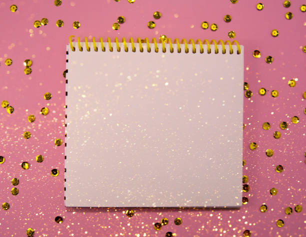 Christmas concept writing in notebook on a pink background