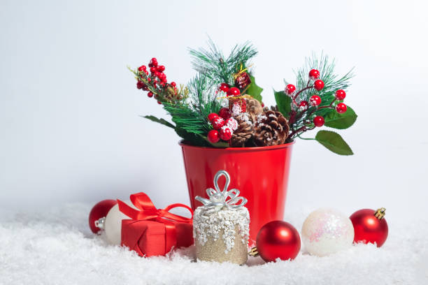 istock Christmas card composition with snow and Christmas tree branches decoration and present boxes on the white background 1290232148