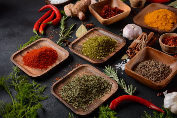 istock Variety of spices and herbs on kitchen table 1290233217