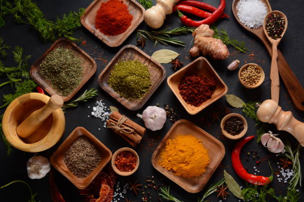 istock Variety of spices and herbs on kitchen table 1290233370