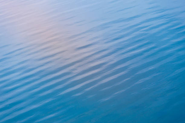 Sunset reflection on water surface Calm sea water reflection. still water stock pictures, royalty-free photos & images