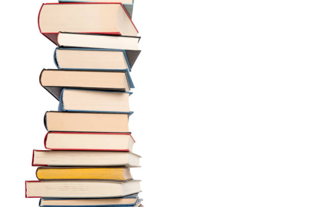 istock Pile of books stacked on a blue background with space for copy 1290234575