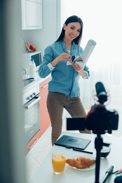 istock Gladsome female architect demonstrating color guide in the kitchen 1290234692