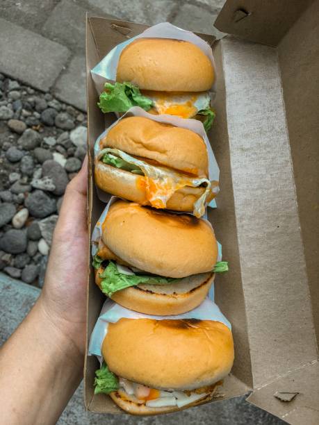 istock Four Burgers in Paper Box 1290237458