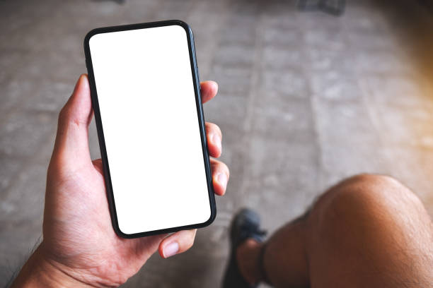 istock a hand holding and showing mobile phone with blank white screen in cafe 1290238541