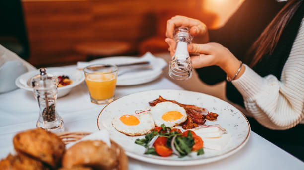 Young woman having breakfast at bedroom