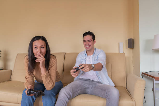 istock Excited Young Couple is Spending a Great Time while Playing Video Games. 1290240511