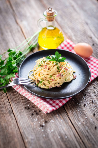 istock Spaghetti alla carbonara. Pasta with pancetta, egg, parmesan cheese and cream sauce. 1290240606