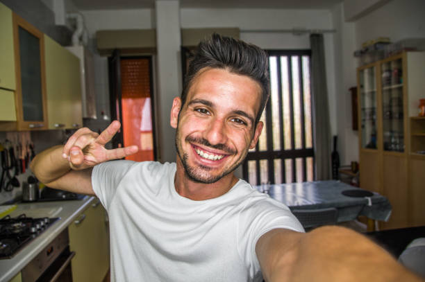 istock Handsome caucasian man taking a self portrait indoor at home 1290241730