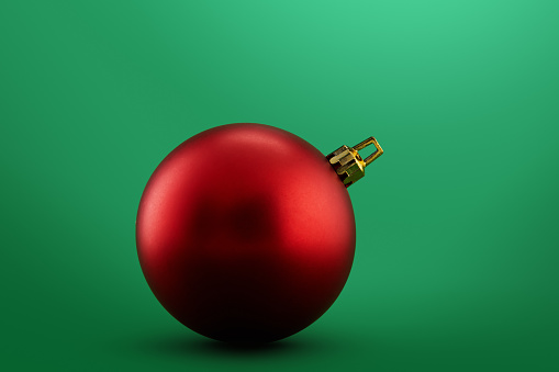 Red Christmas ball on green background