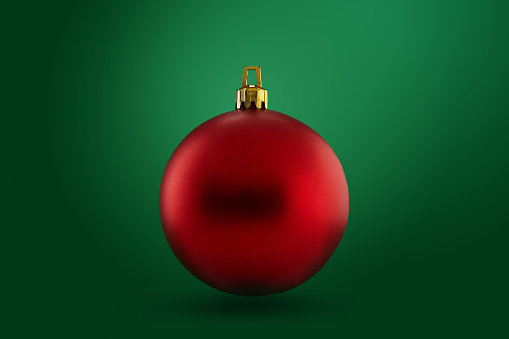 Red Christmas ball on green background