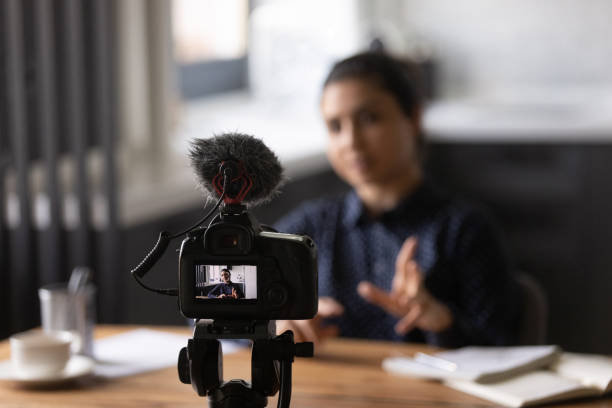 istock Young indian lady trainer shooting video lecture using digital camera 1290242657