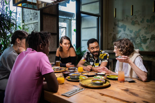 istock Young multi-ethnic friends celebrating something in a cafe 1290243164
