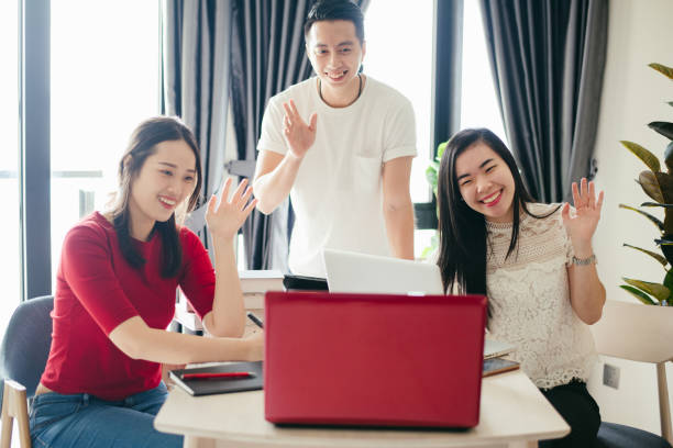 istock Three friends online meeting with digital devices on table at home 1290243221