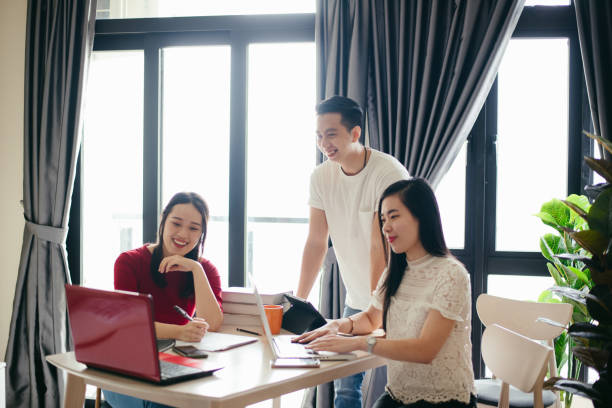 istock Three friends online meeting with digital devices on table at home 1290243222