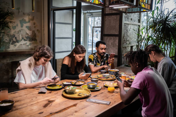 istock A multicultural group of students sharing a meal in a cafe and u 1290243260