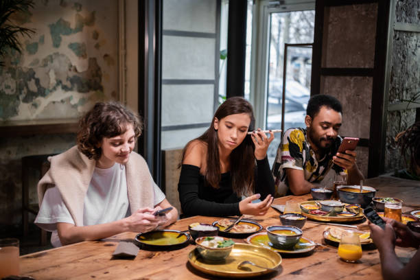 istock A multicultural group of students sharing food in a cafe and usi 1290243268