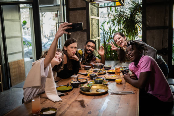 istock Group of students taking a self-portrait with the phone camera 1290243288