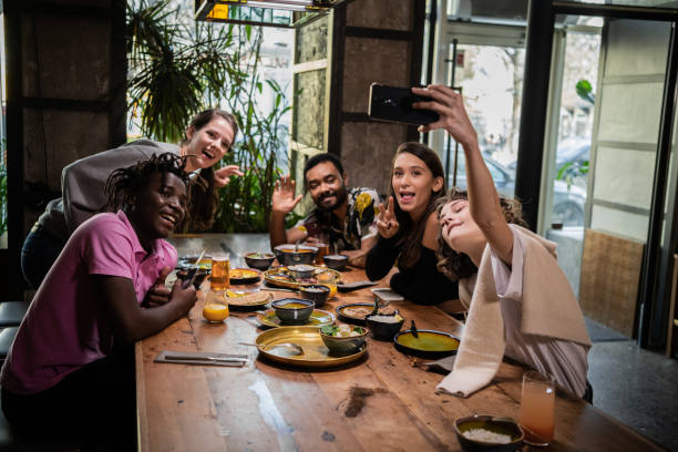 istock Group of students taking a self-portrait with the phone camera 1290243296