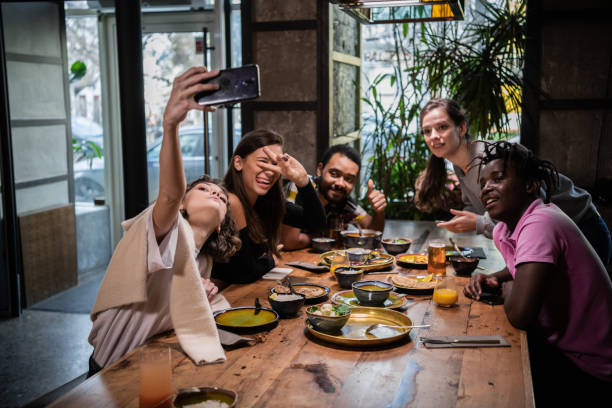 istock A multicaltural group of students taking photos of themselves, m 1290243309