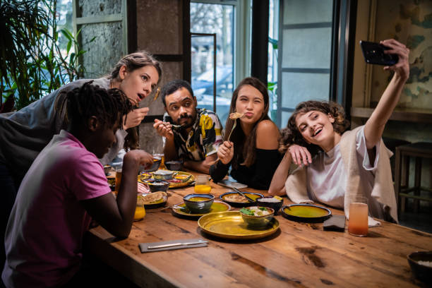 istock Group of students making a self-portrait with the phone camera 1290243329