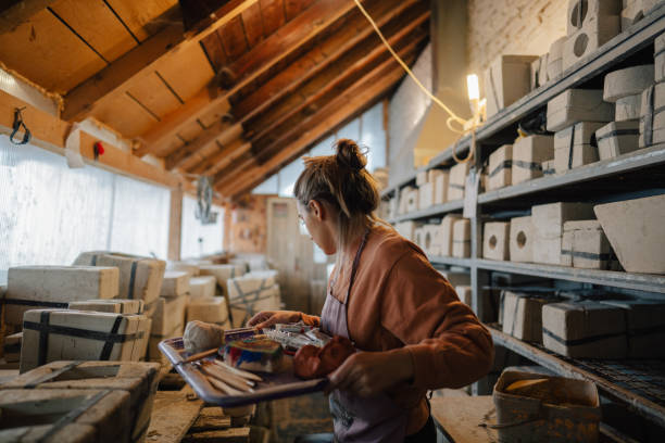istock Young woman painting the pottery in her studio 1290247719
