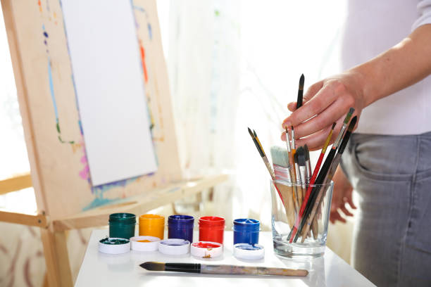 istock painter's hand holds brush 1290249148
