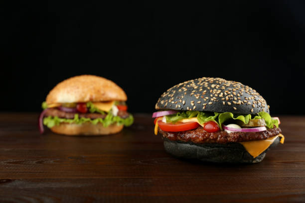 istock Two burgers are on wooden background 1290249191